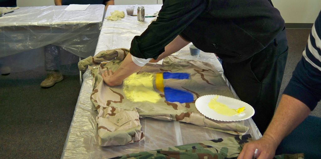 Photo of two Veterans painting